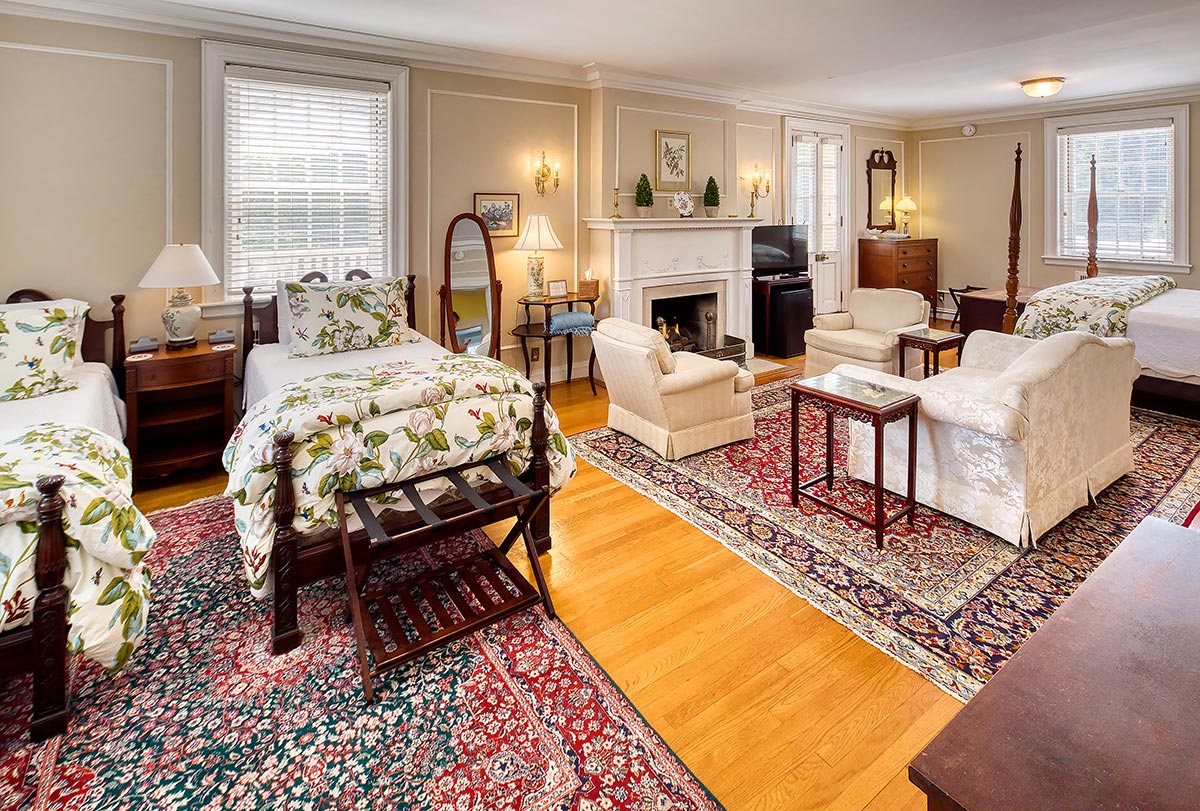Large suite with twin beds, king bed, fireplace and sitting area at Hornsby House Inn